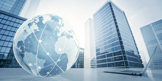 Laptop and a glass globe on a desk showing the global network of an international PEO.